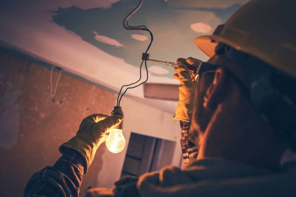 Electrician working on a bulb
