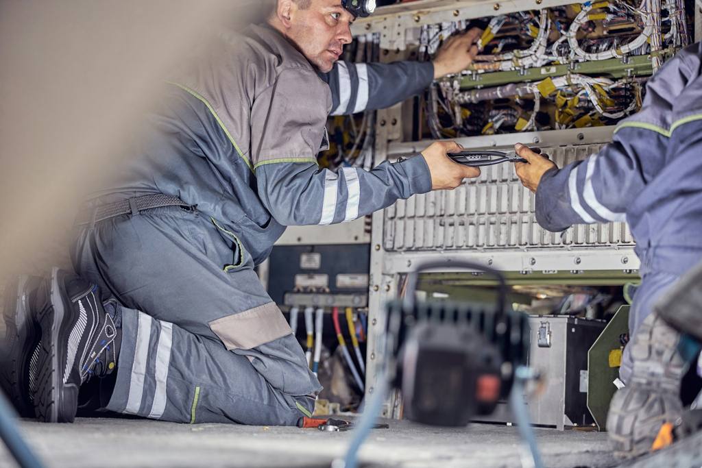 Two person working on some wires