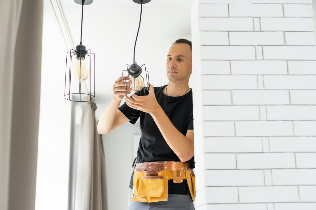 A person installing a lamp