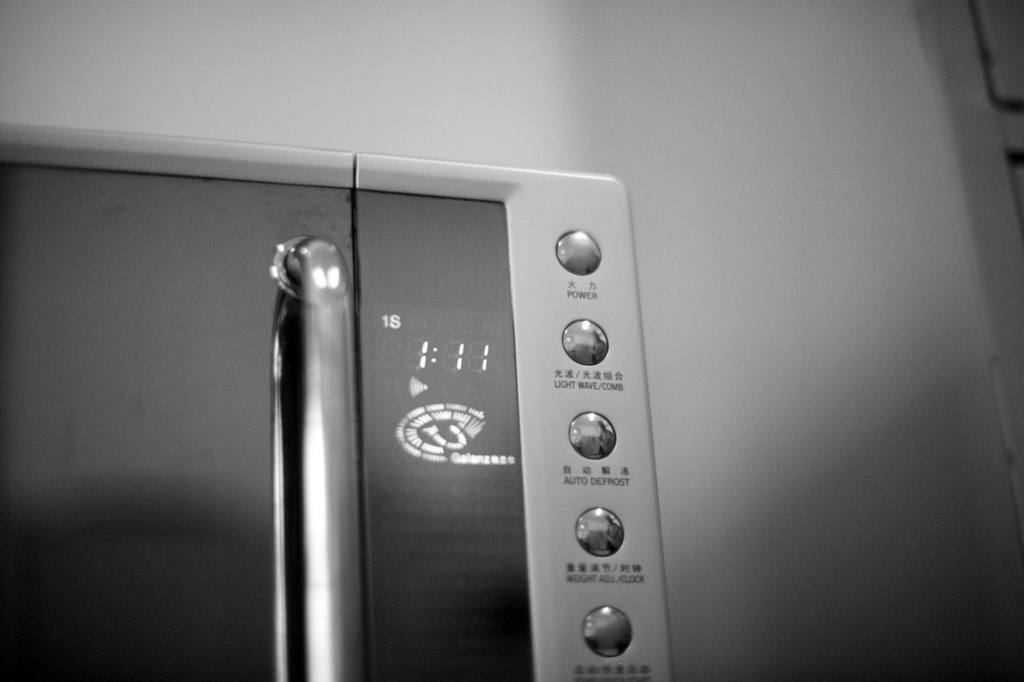 A black and white photo of a microwave