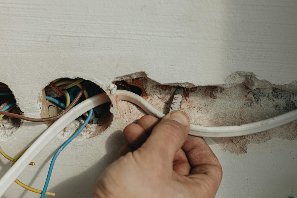 A person fixing an electrical wire