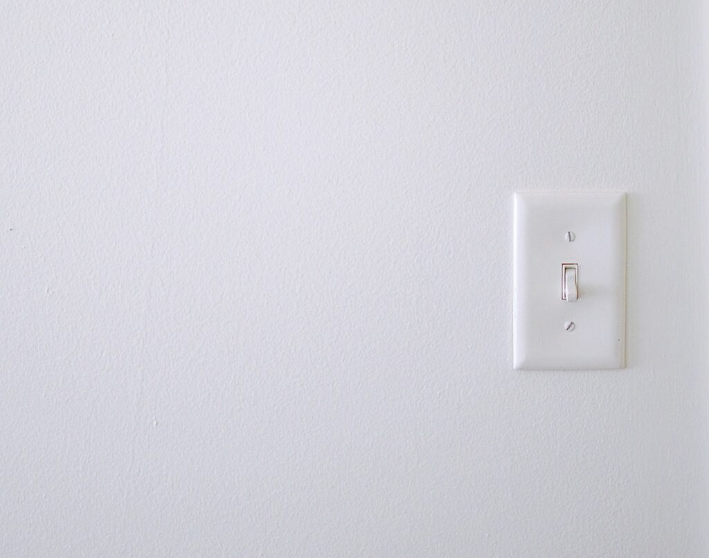 A white wall with light switch