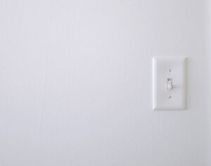 A white wall with light switch