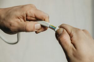 A person holding a white cable