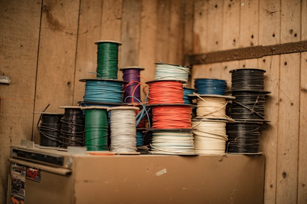 Blue and green thread on brown walls